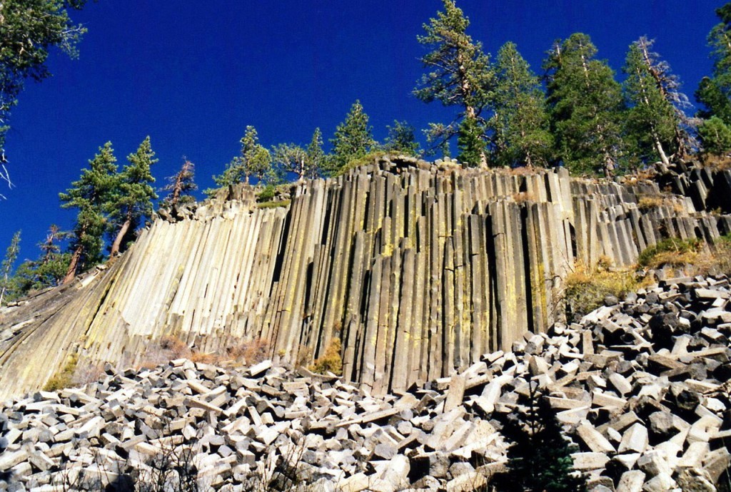 The longer fragments of basalt at the base of the cliff are much larger than a person at Devils Postpile National Monument